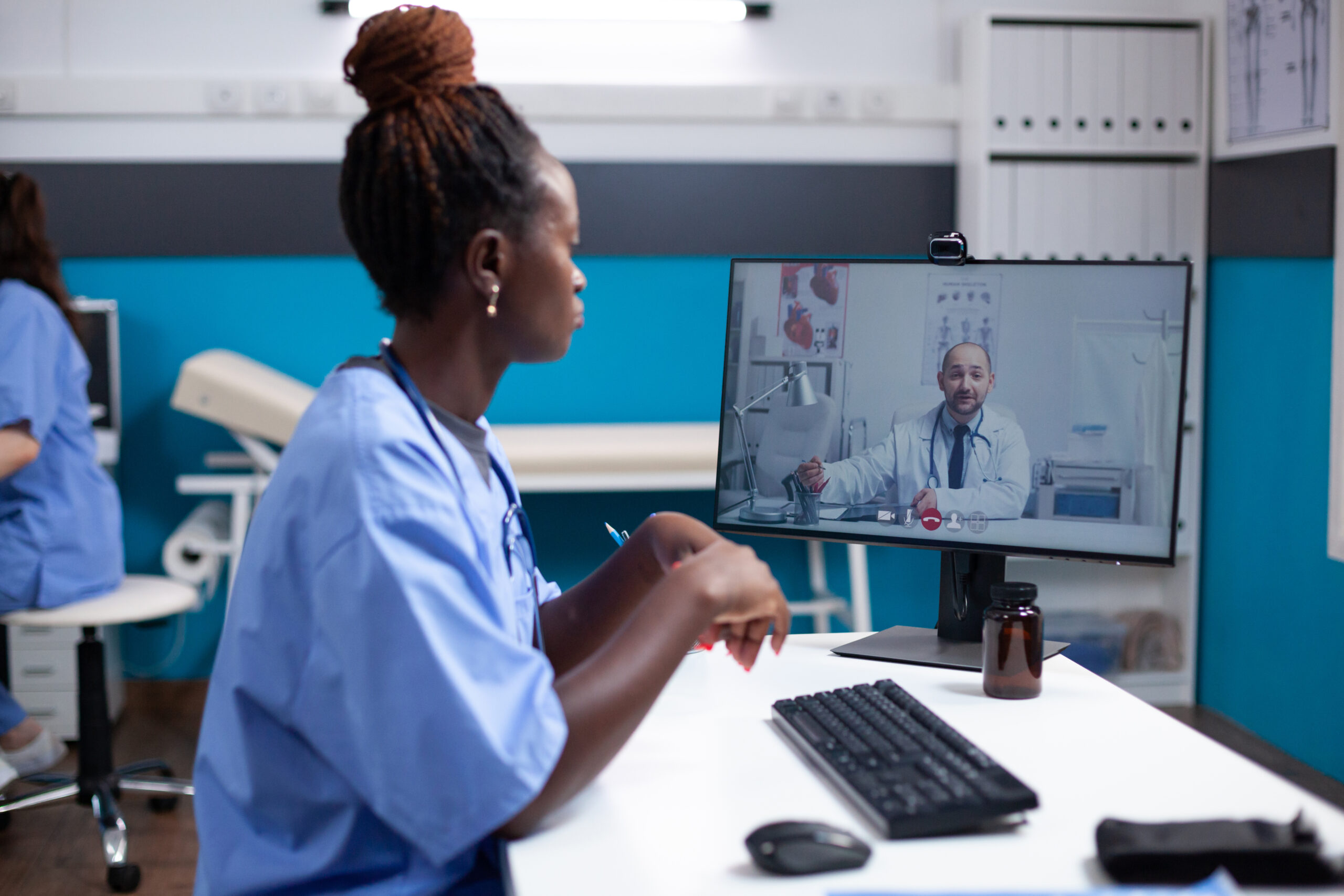 Nurse in videocall listening to doctor